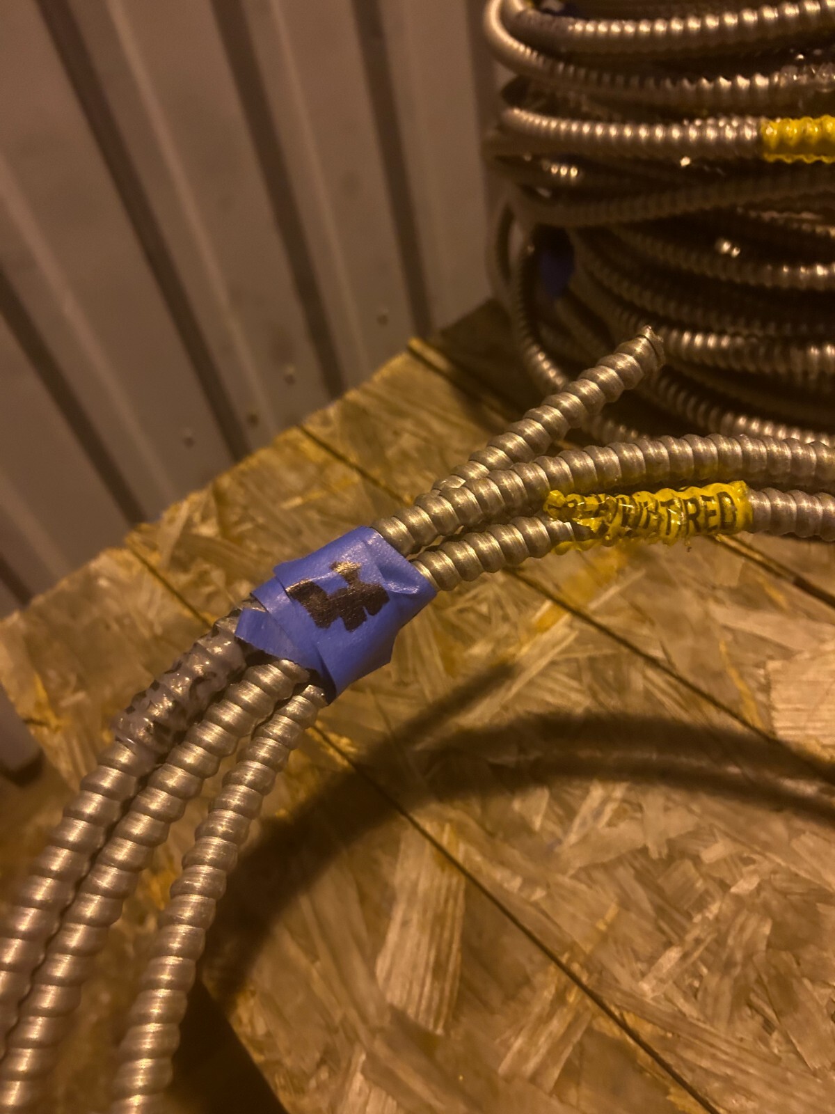 About 12ft of flexible metal conduit with wire inside