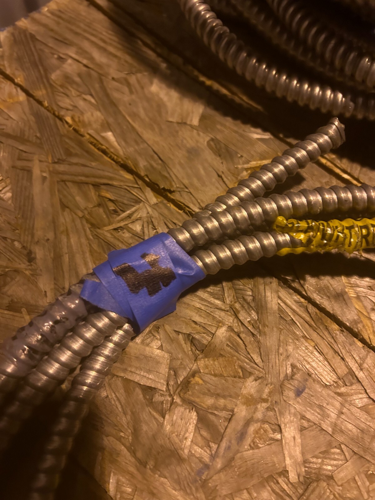About 12ft of flexible metal conduit with wire inside