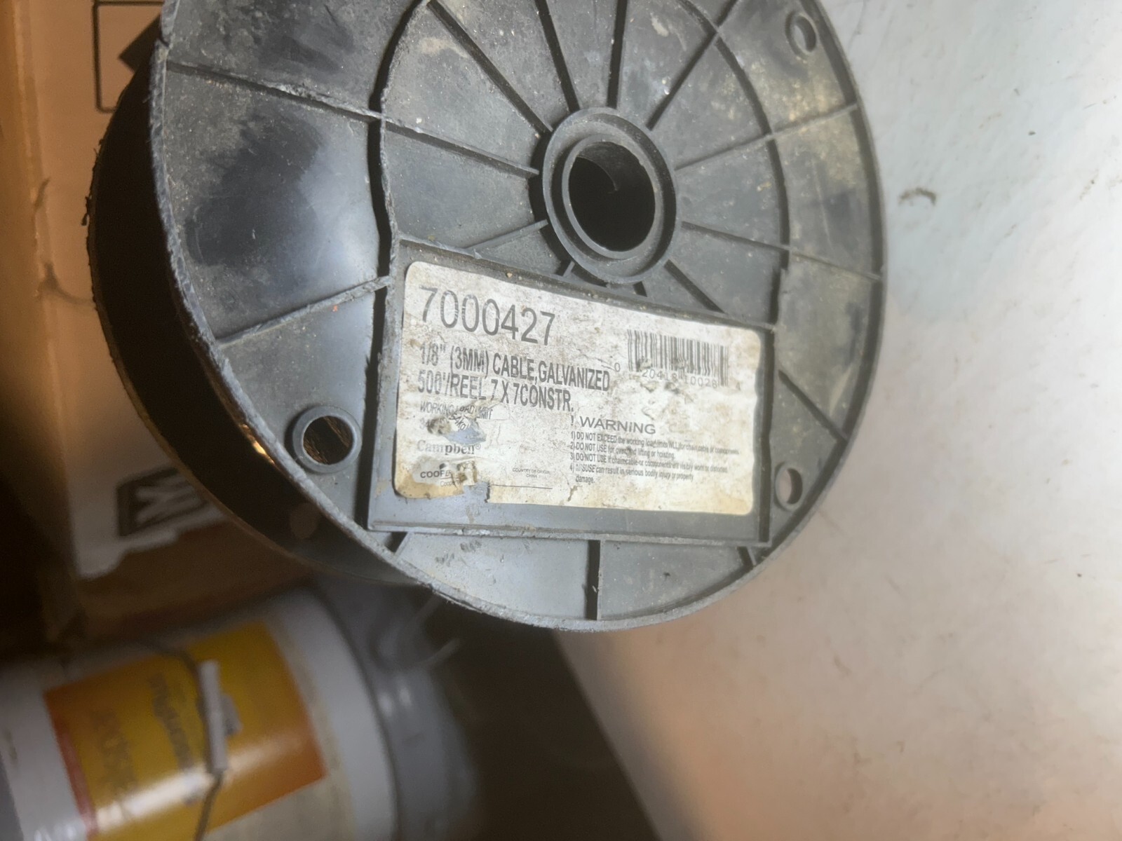 INCOMPLETE spool of galvanized cable – black plastic spool holder cracked